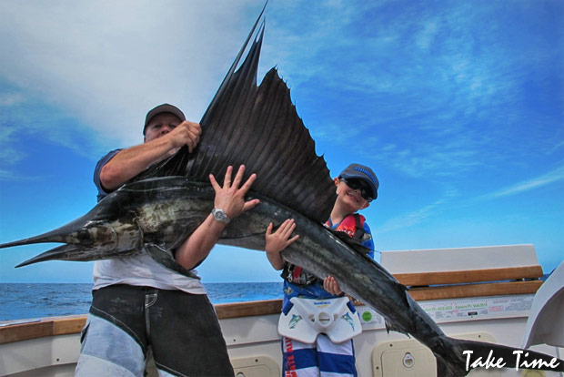 Geoff Harris helps young PJ Bennett hold up his sail for a quick photo before release.